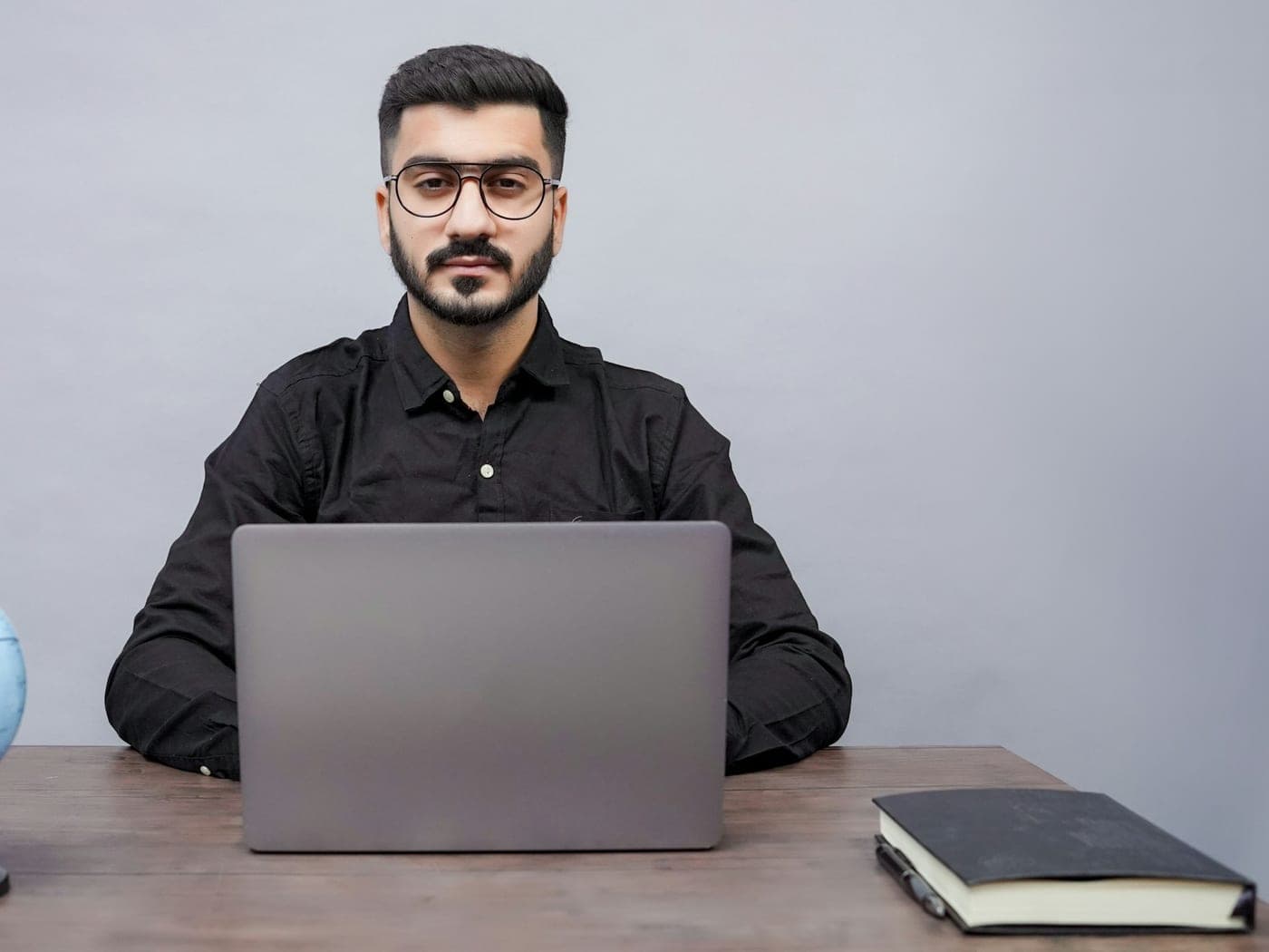 A man sitting at a desk with a laptop